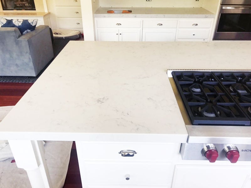 wolf stove with marble countertop and cabinets
